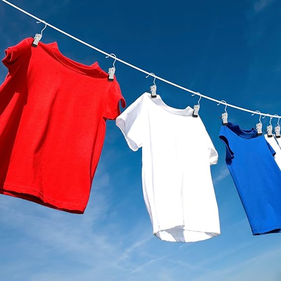 Clip hangers drying shirts on outdoor clothesline