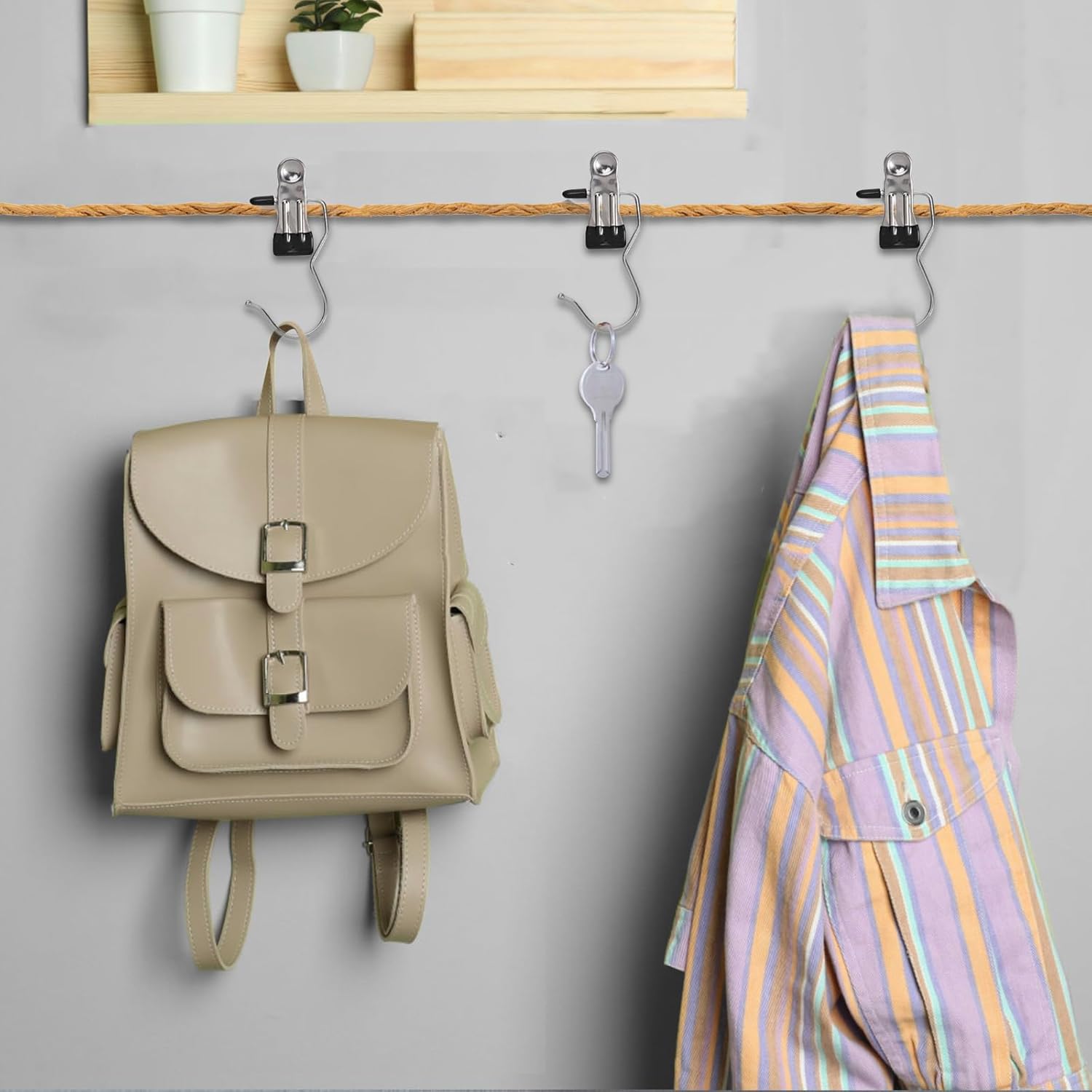 Clip hooks holding backpack, key, and shirt on hanging line
