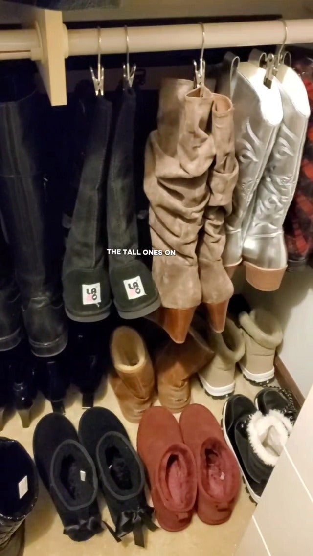 Boots hanging in closet with metal clip hangers