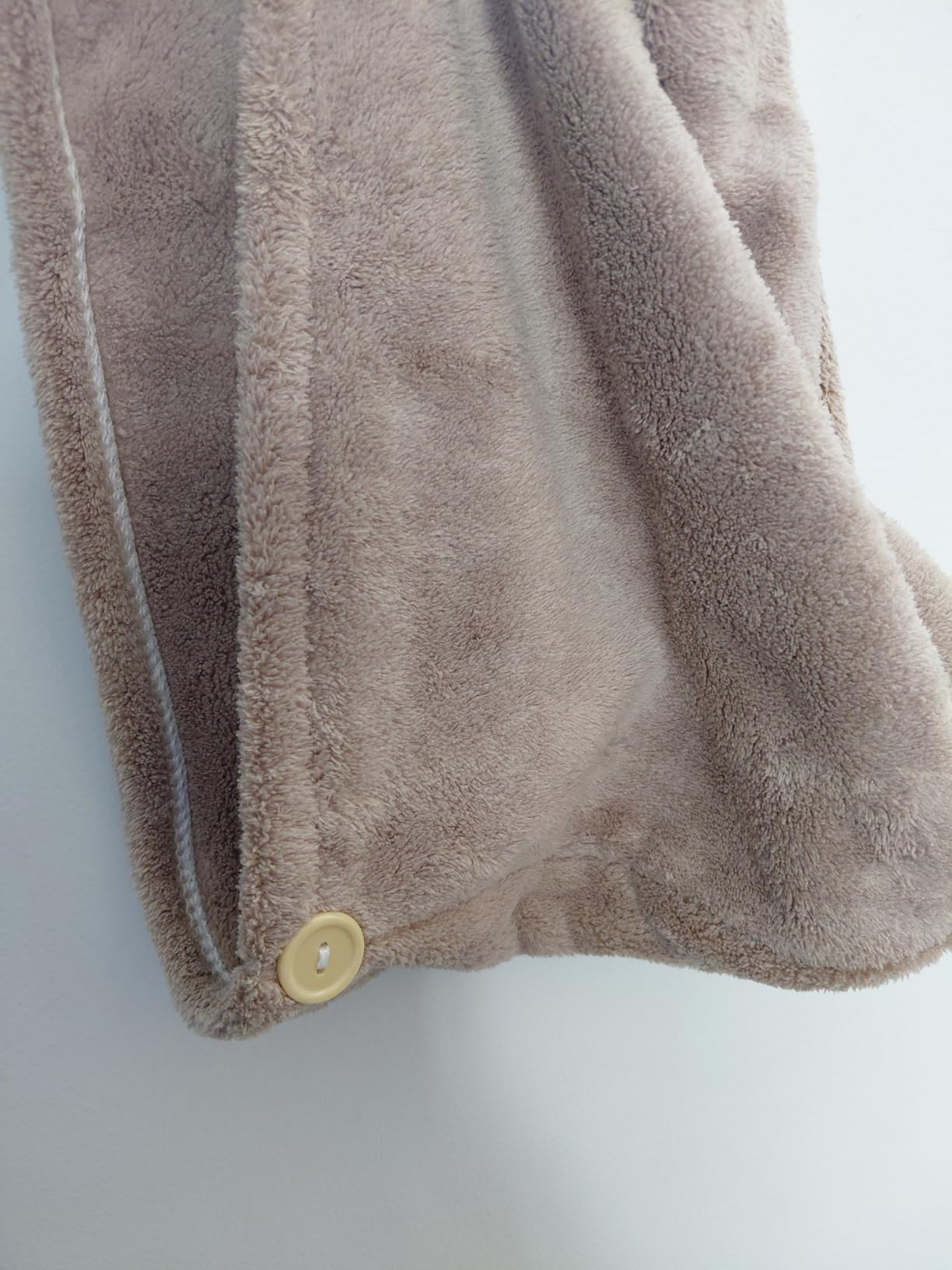 Customer photo showing button detail on microfiber hair cap