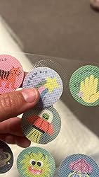 Hand holding several mosquito repellent stickers
