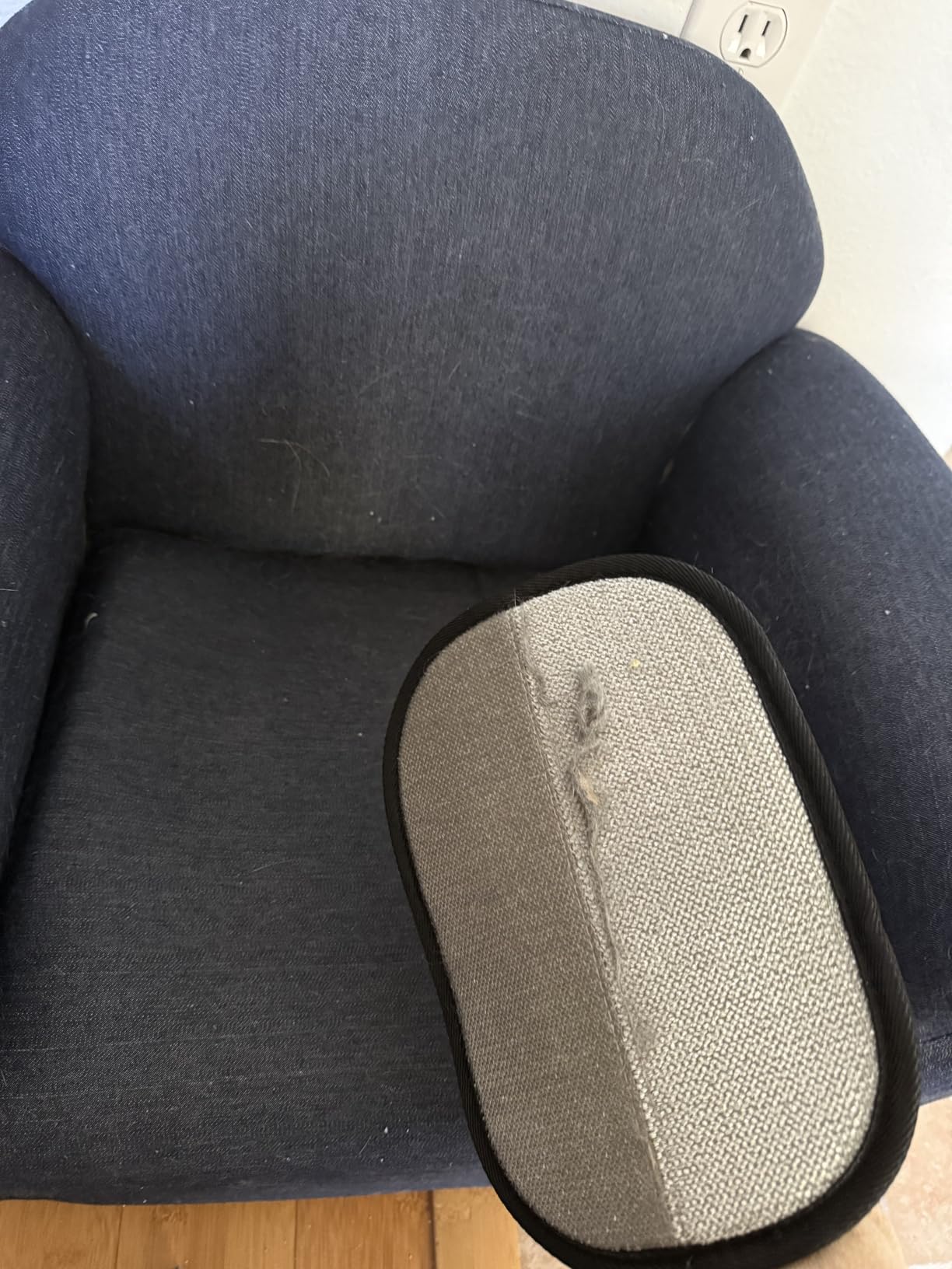 Pet hair remover glove on fabric chair